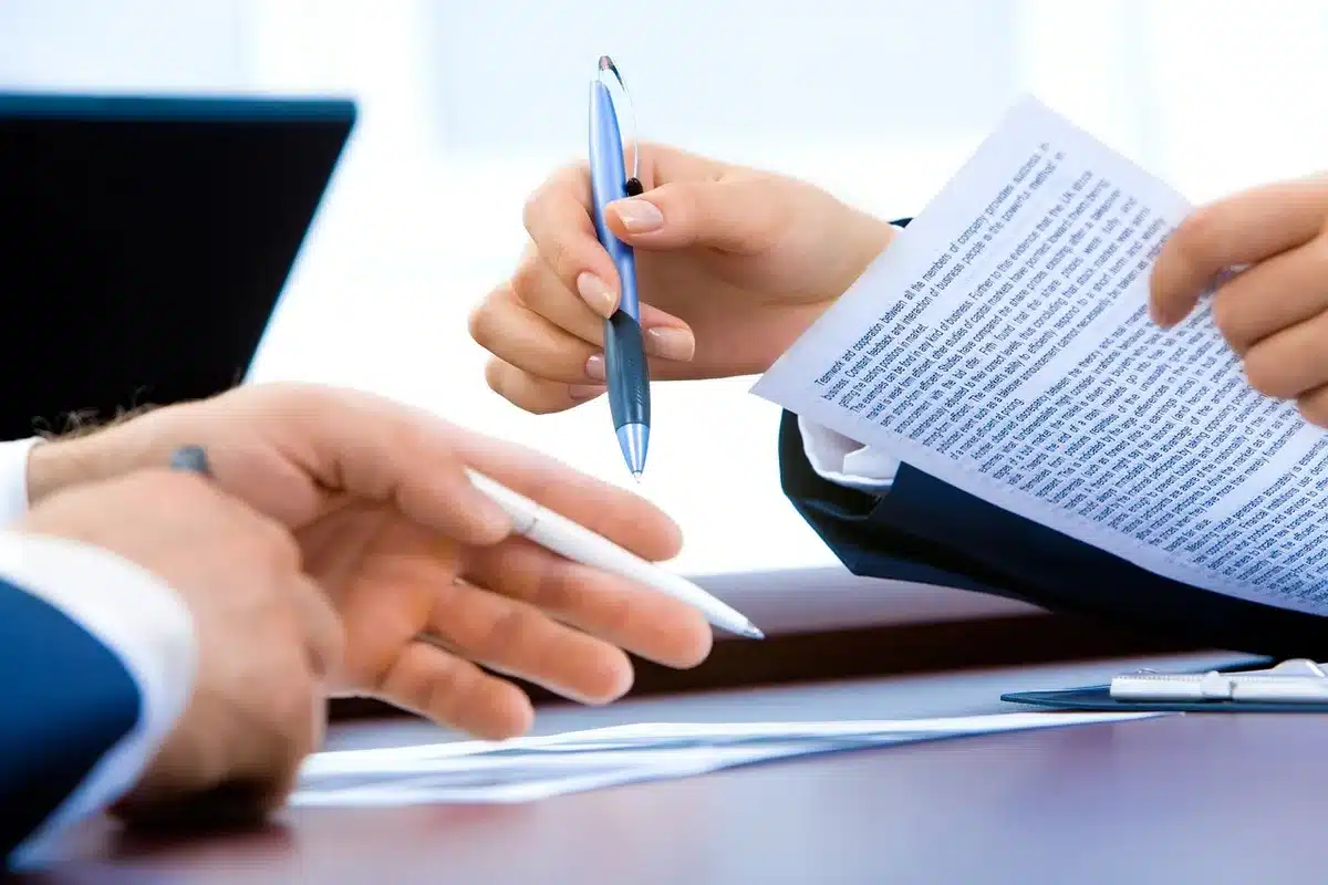 Carpeta con identificaciones oficiales y documentos laborales sobre una mesa