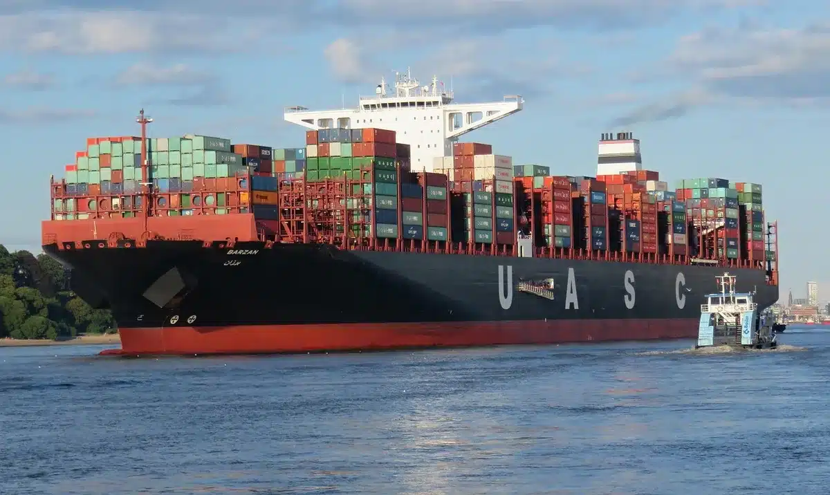 Contenedores en puerto con operarios y grúa, ilustrando fricción aduanera