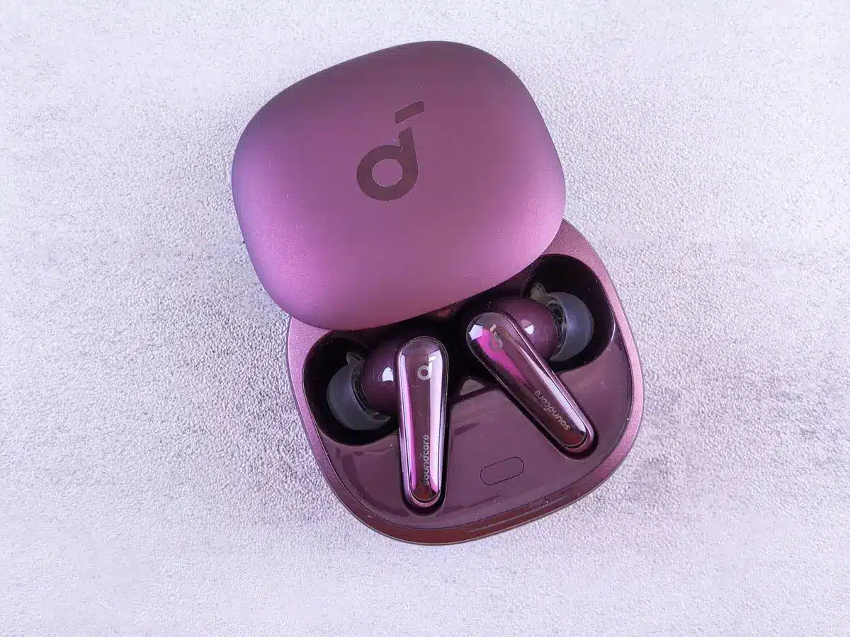 empty retail shelf with a single elegant unbranded earbud case in gold on display, price tag blurred and unreadable