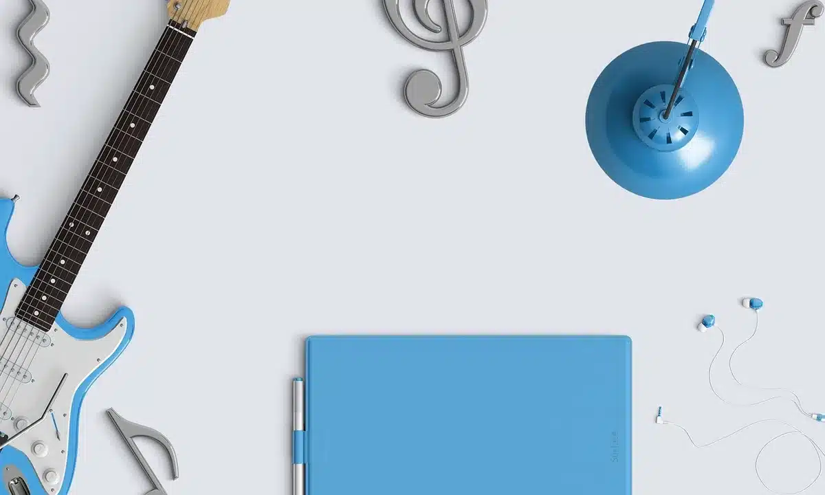 close-up of an anonymous person’s hands holding an unbranded open-ear earbud next to a compact charging case on a plain table