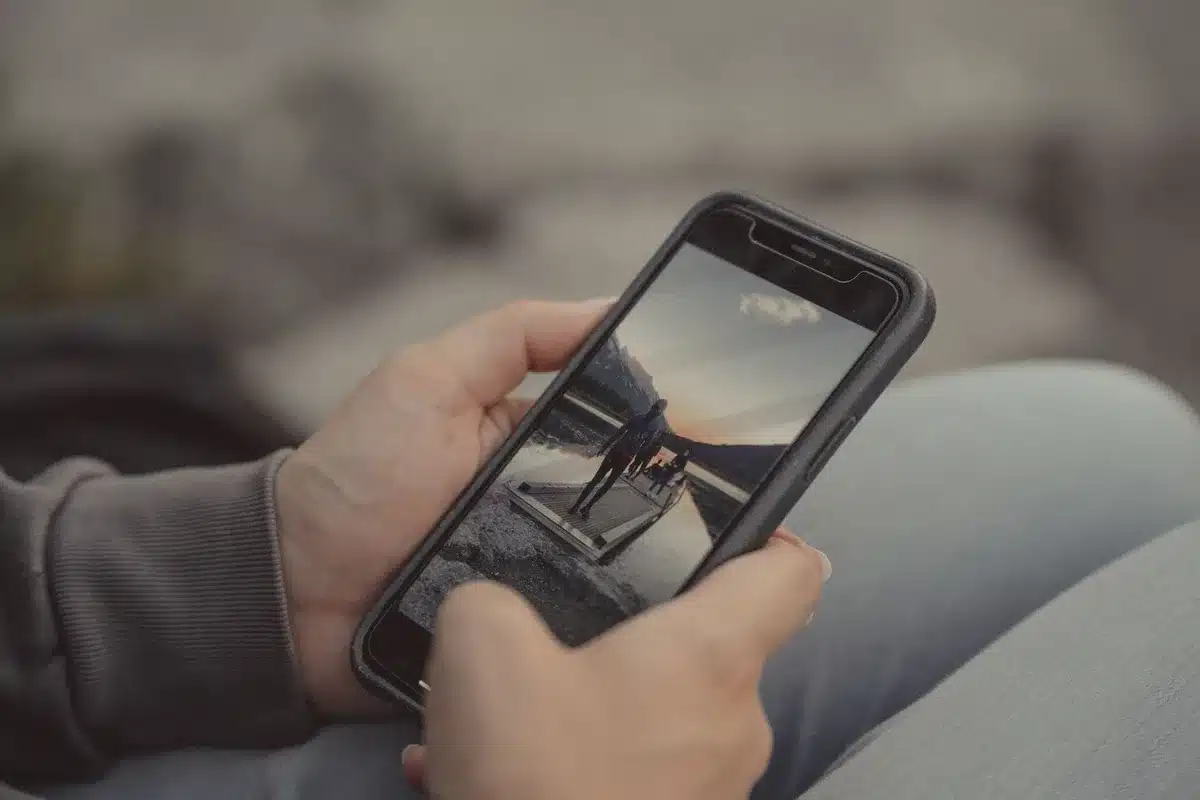 Anonymous hands holding an unbranded phone, index finger hovering over a newly added generic settings shortcut on the home screen