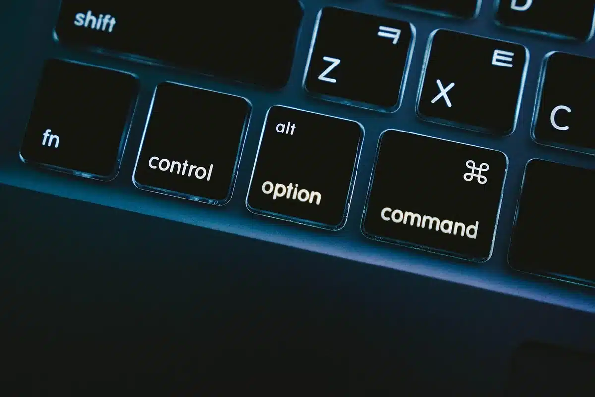 Close-up of an anonymous router and a laptop terminal showing Android Debug Bridge commands, no logos or identifiable devices
